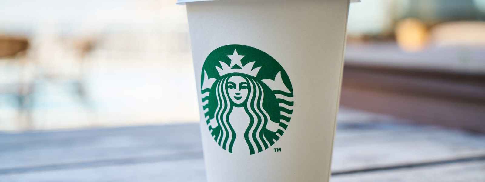 closed white and green starbucks disposable cup