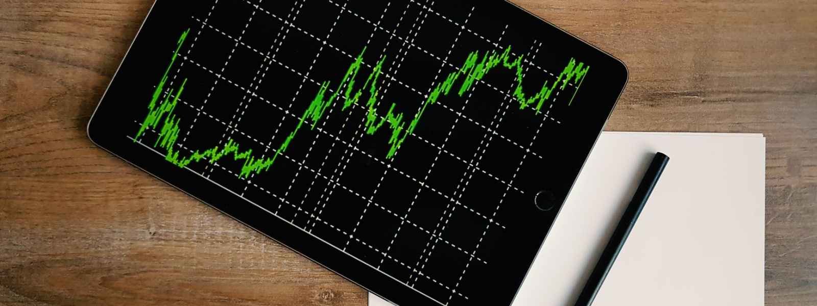 space grey ipad air with graph on brown wooden table