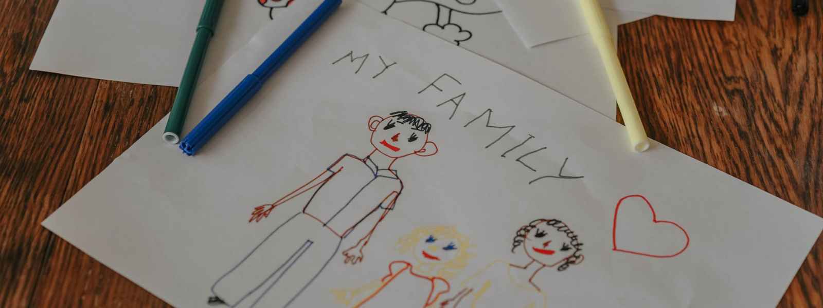 close up of a child s drawing of a family on paper