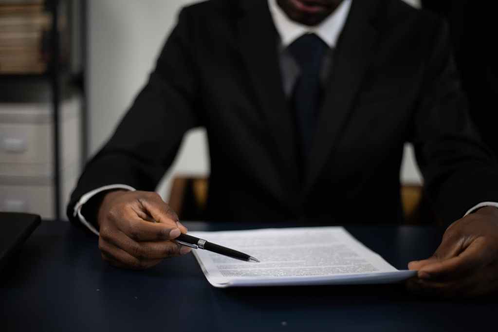 a man in a suit reading a document