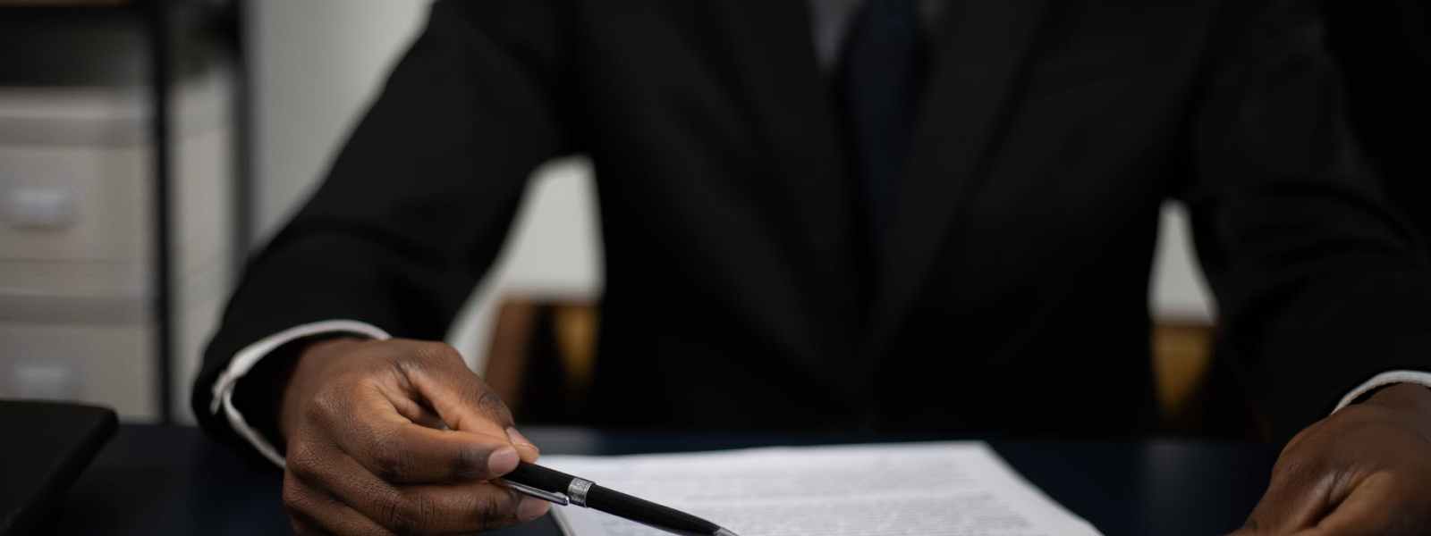 a man in a suit reading a document