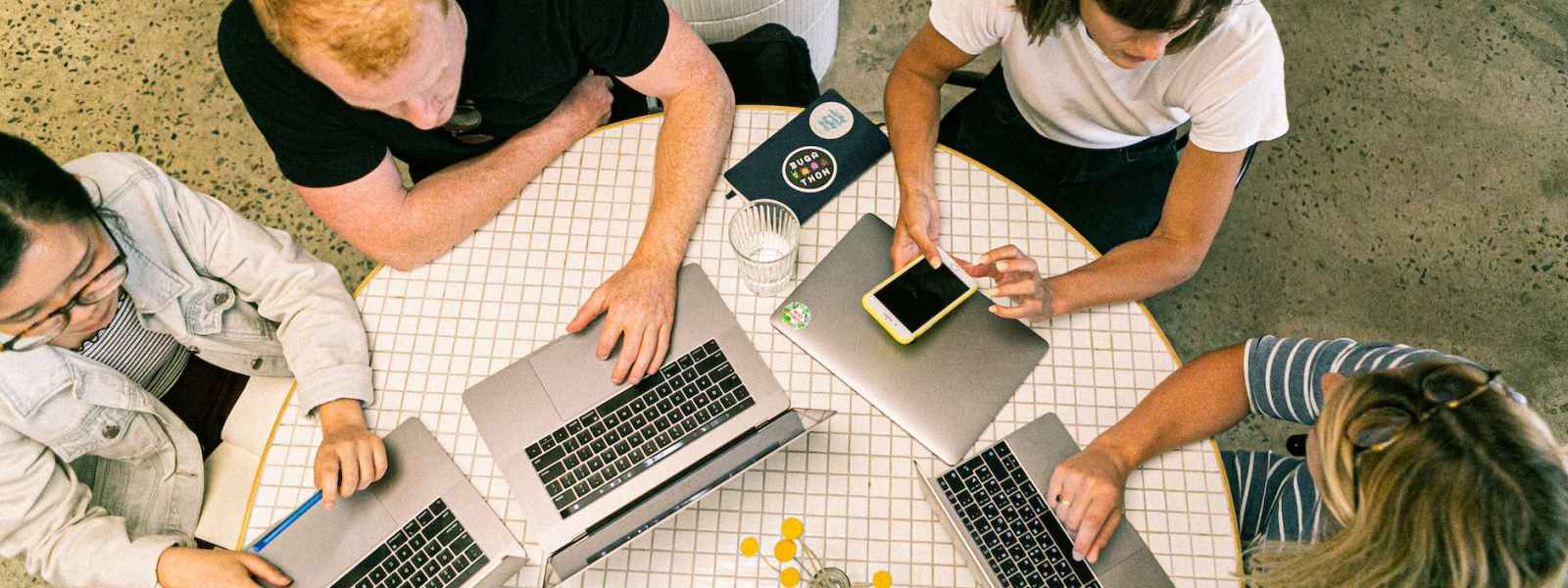 four people using laptop computers and smartphone