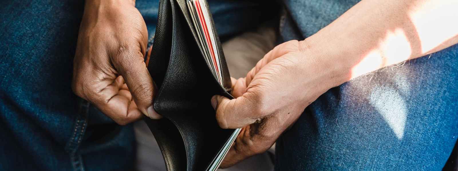 man looking at an empty wallet
