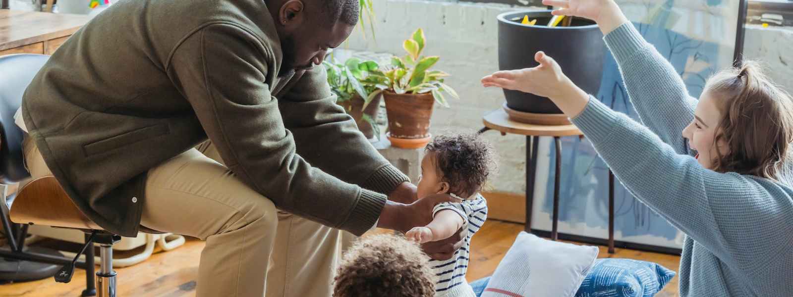 happy mother rejoicing first step of black baby with family