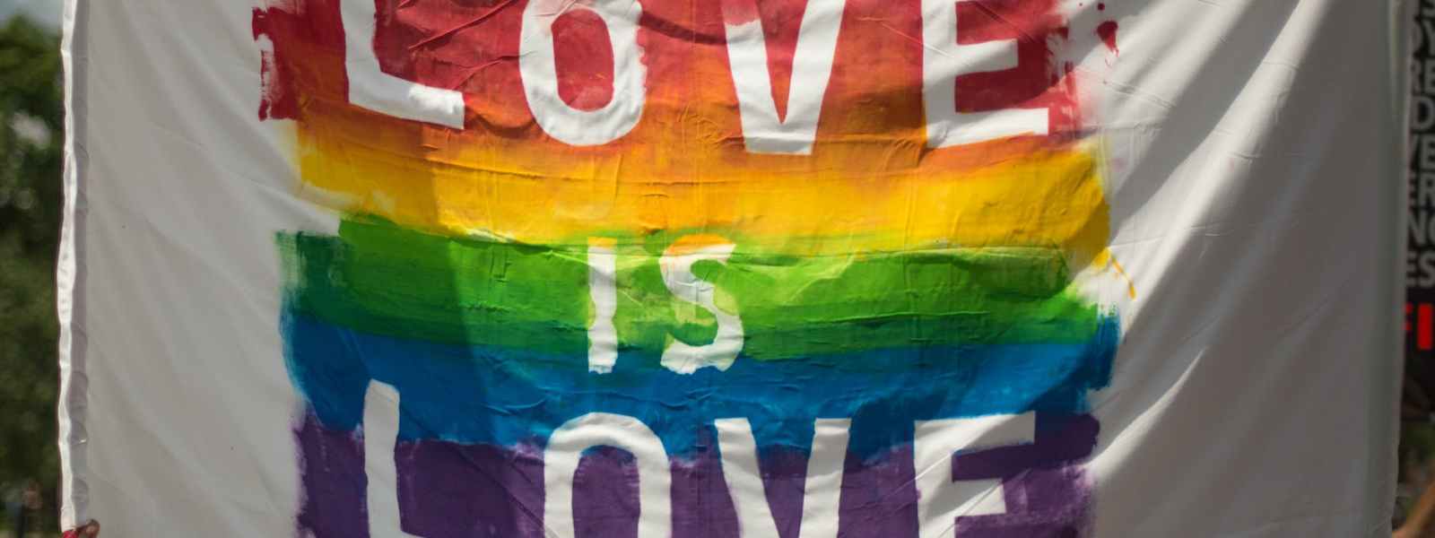 white and multicolored love is love banner
