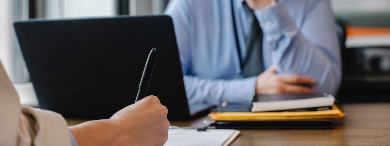 woman filling job application form in office with boss