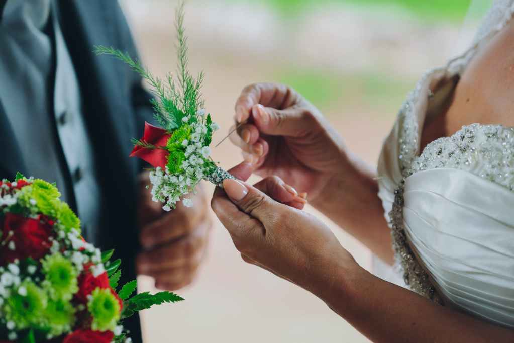 woman holding red flower