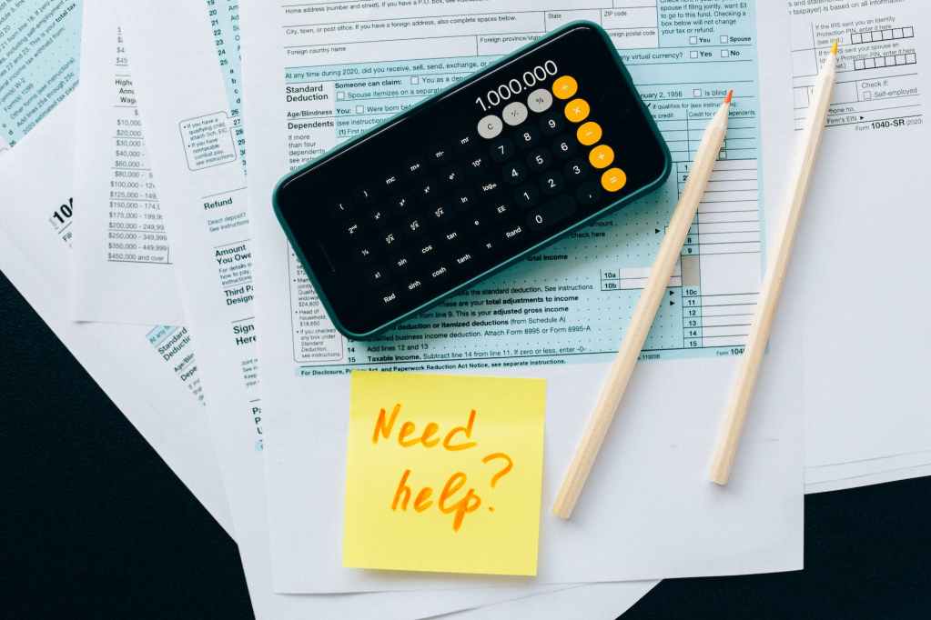 black smartphone on top of documents