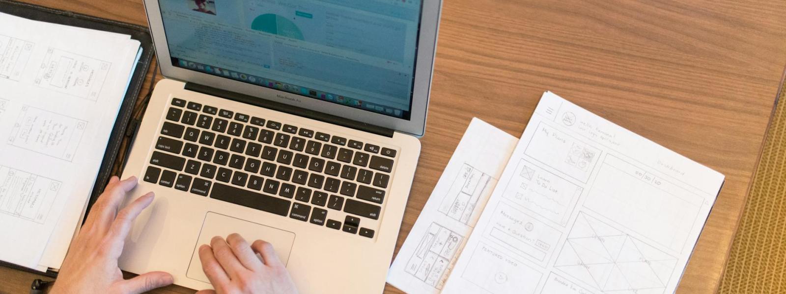 person s hands on top of macbook air