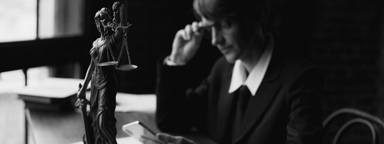 grayscale photo of a lawyer using a mobile phone