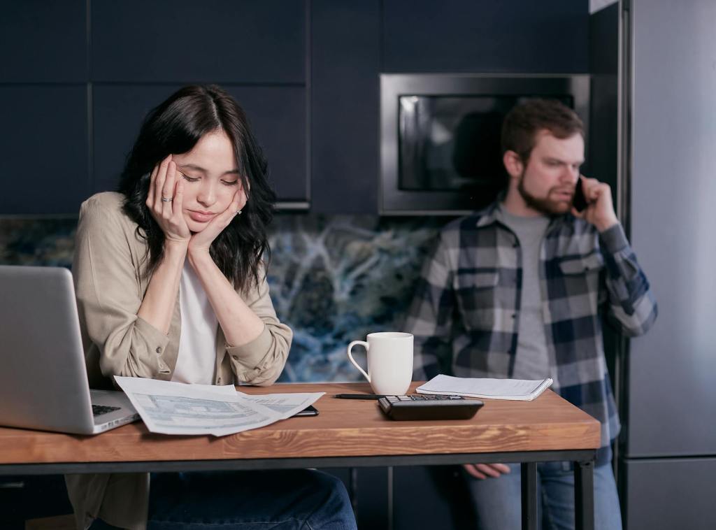 woman in white long sleeve shirt sitting beside man in black and white checkered dress shirt