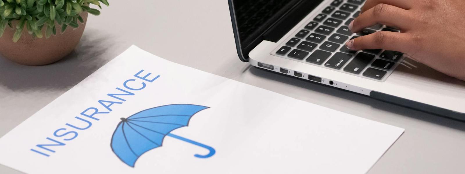 a paper beside a person typing on a laptop