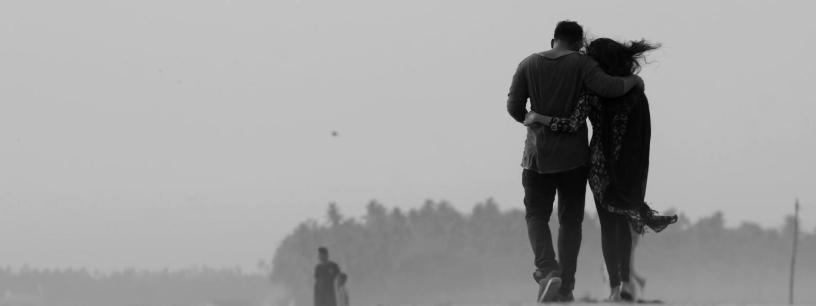 grayscale photography of couple walking on ground