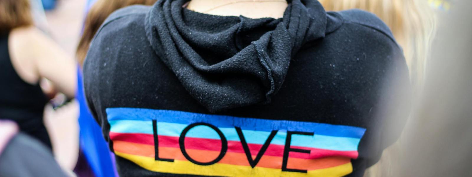 woman in black and multicolored love print hoodie