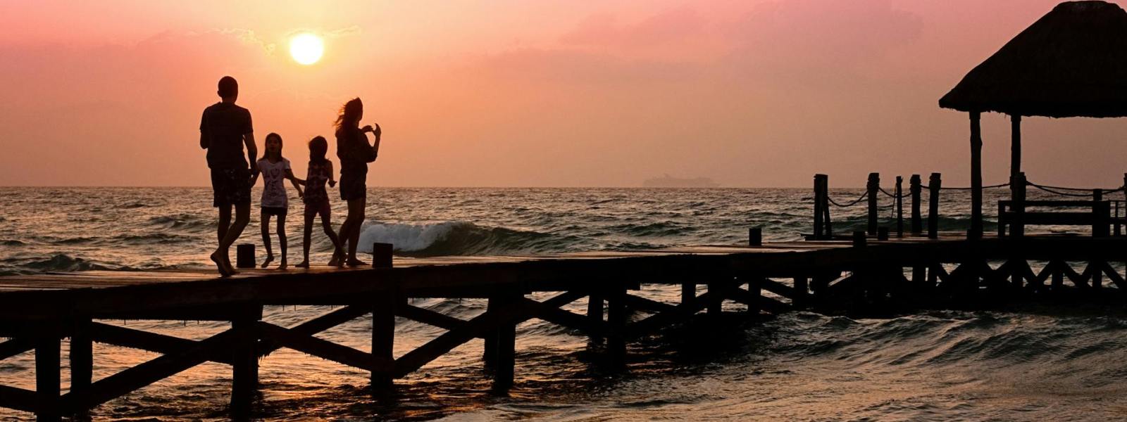 people standing on dock during sunrise